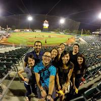Dr. Brian Park (front row) enjoys a Sacramento River Cats game this summer with friends, including former optometry school classmates.